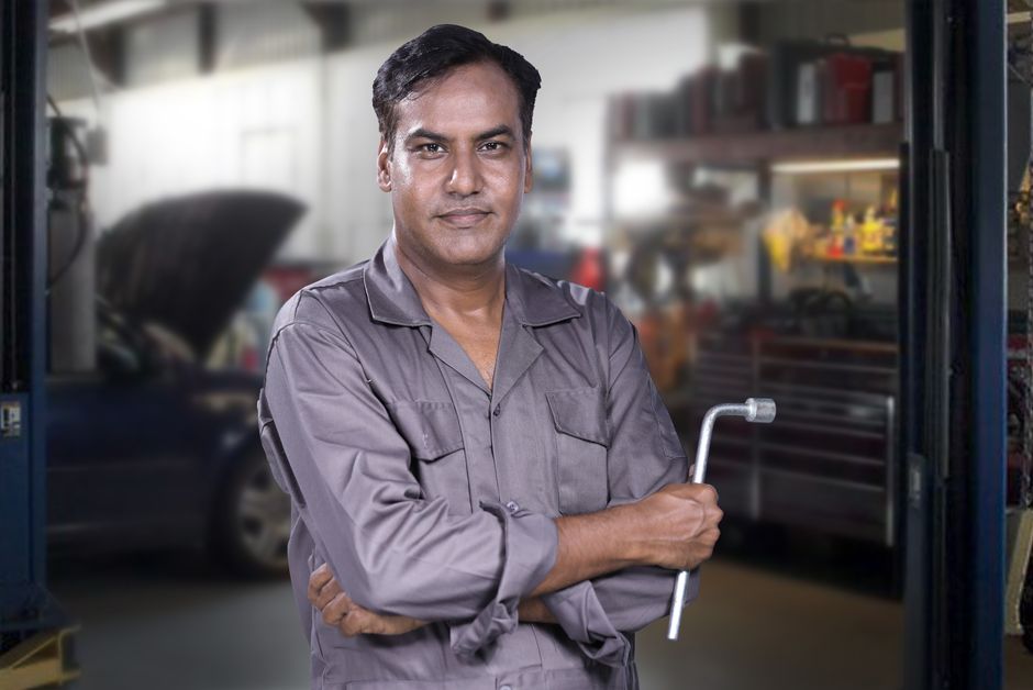 Smiling car mechanic ready to assist with windshield repair