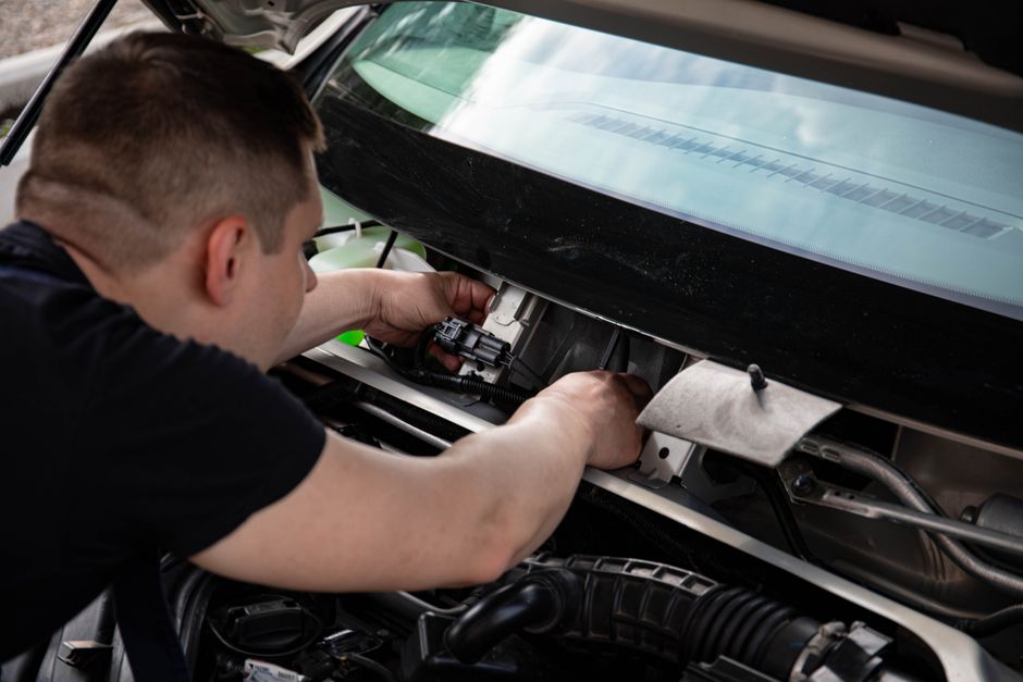 Technician repairing a car window